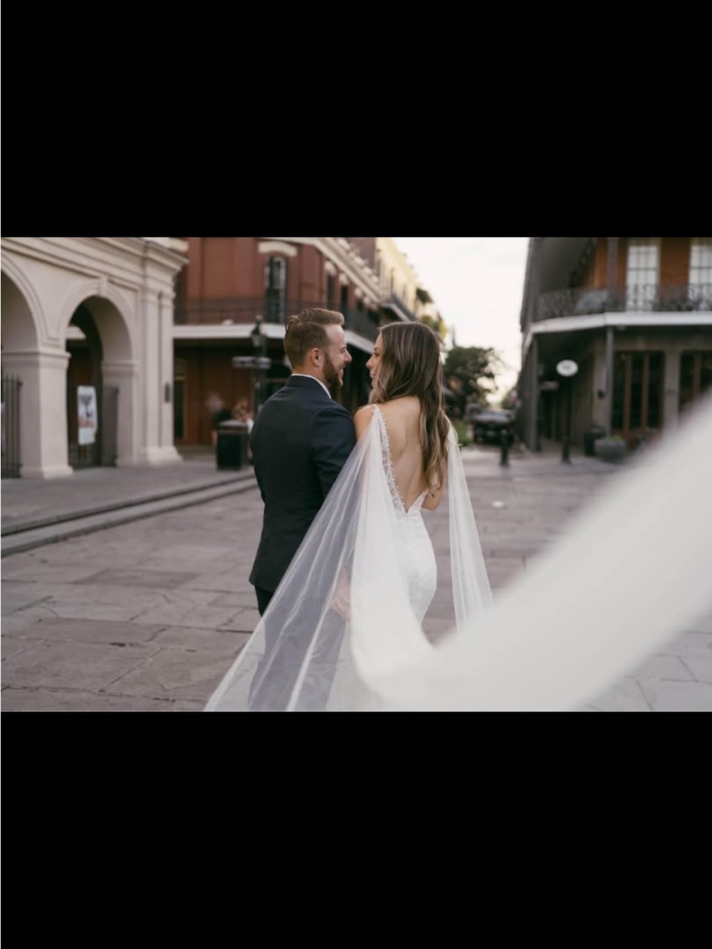 Elegant Open-Back White Bridal Gown with Sheer Cape